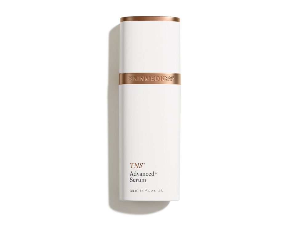 TNS Advanced+ Serum by SkinMedica in a sleek white bottle with a copper accent, promoting skin transformation.